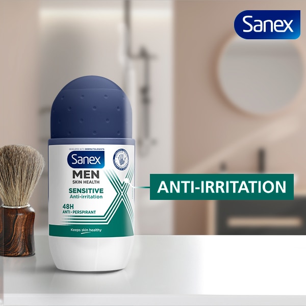 The Sanex Men Sensitive Antiperspirant Roll-on placed on a table with a shaving brush behind it.